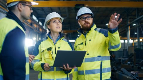 Male,And,Female,Industrial,Engineers,Talk,With,Factory,Worker,While